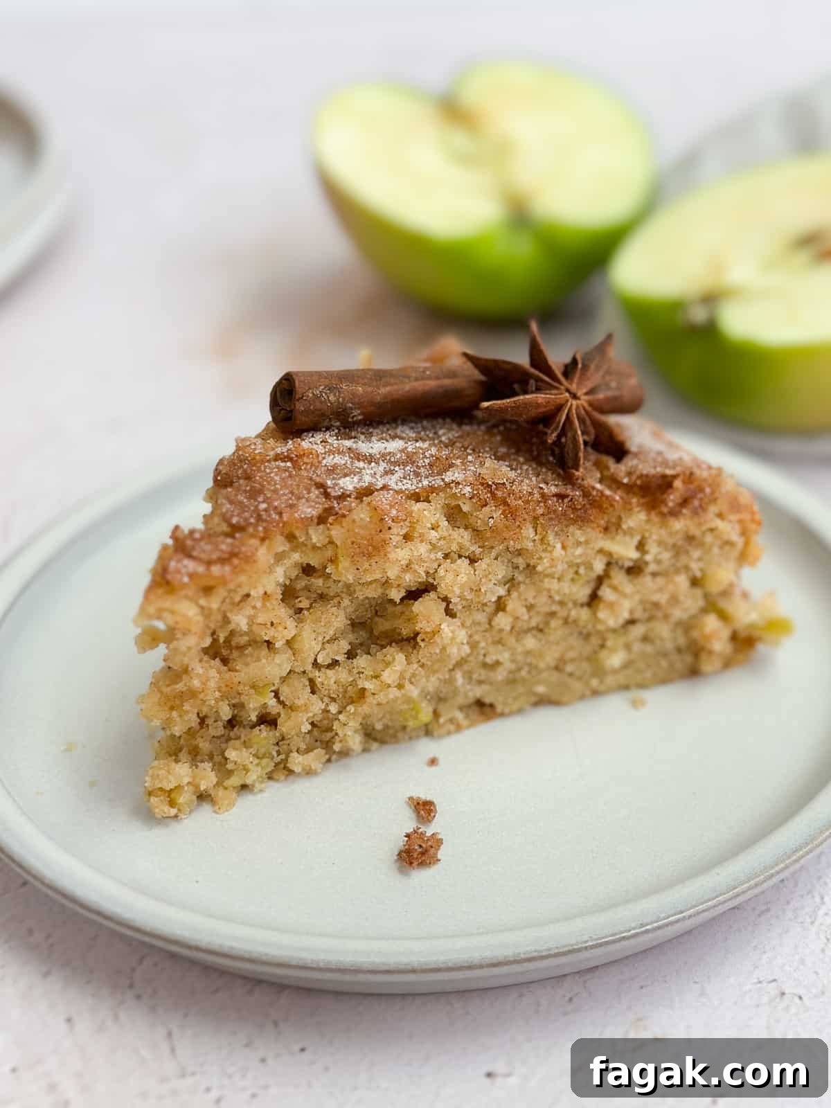 a single slice of apple buttermilk cake on a plate.