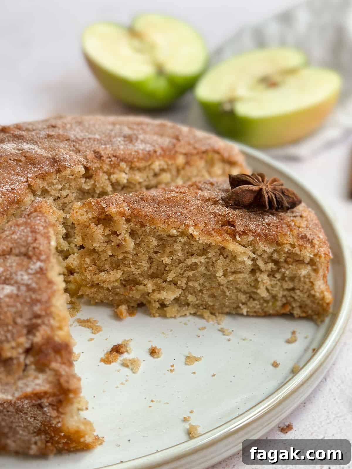 a side view of the cut apple buttermilk cake to see inside texture.