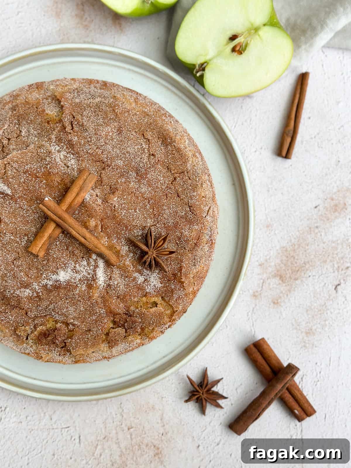 the whole apple buttermilk cake on a cake plate.