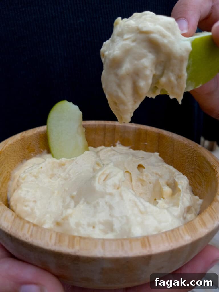 dipping apples in creamy  caramel dip