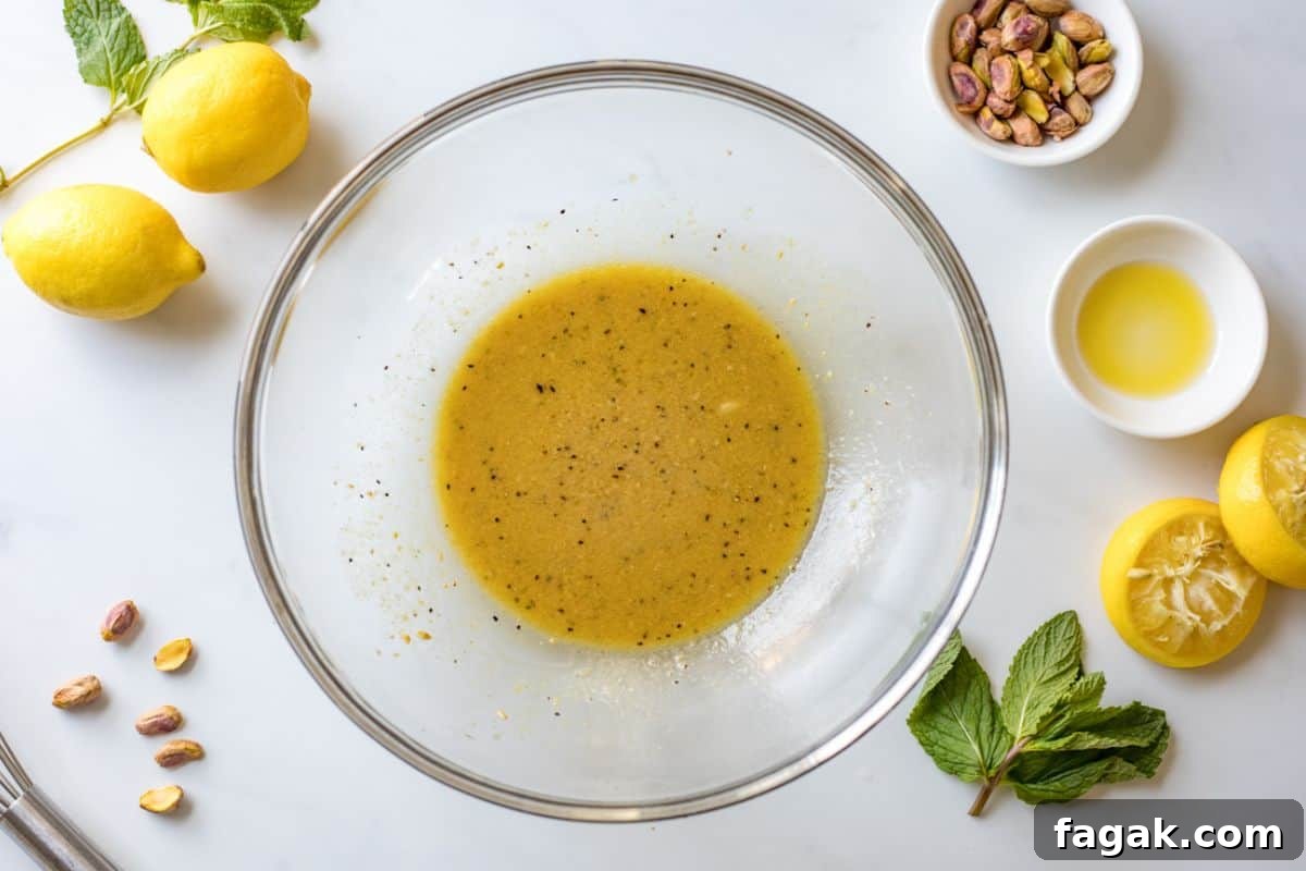 Bowl with lemon honey dressing whisked together for Asparagus salad.