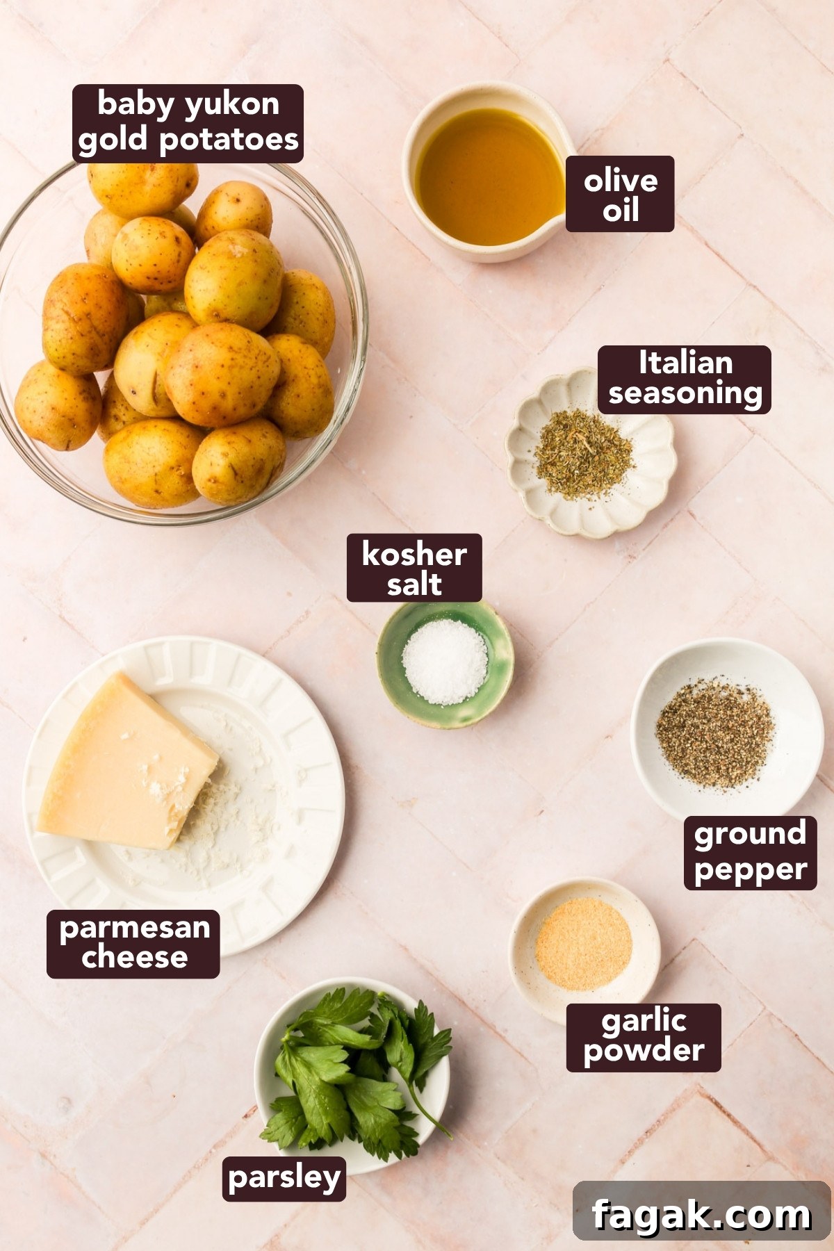 Overhead view of ingredients for crispy parmesan smashed potatoes, including baby Yukon golds, olive oil, spices, parsley, and Parmesan cheese.