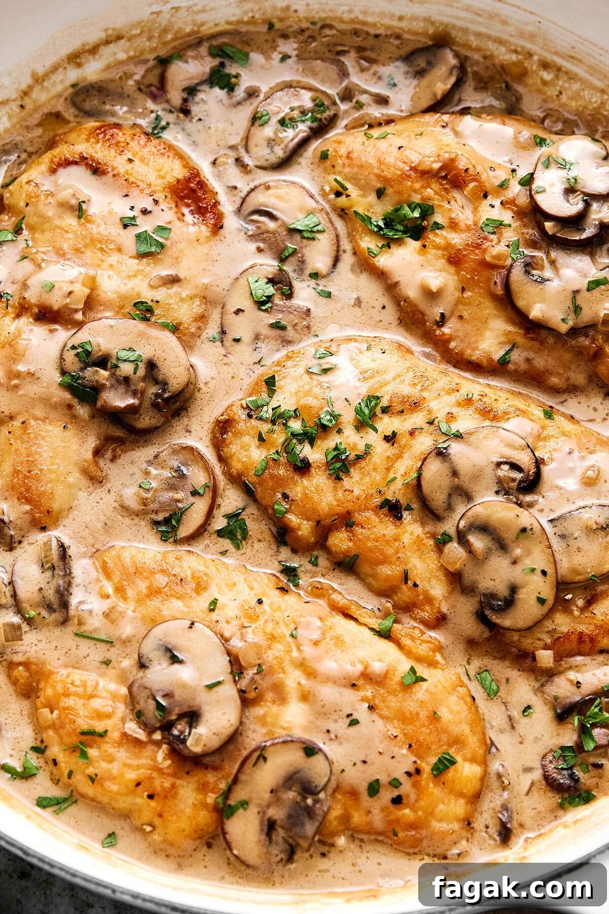Chicken Marsala in a white pan.