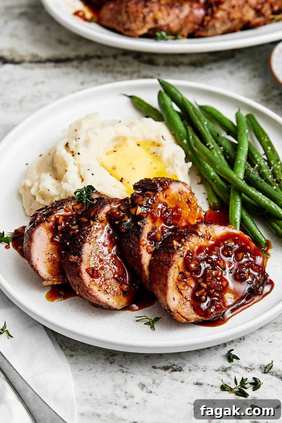 Sliced pork tenderloin with mashed potatoes.