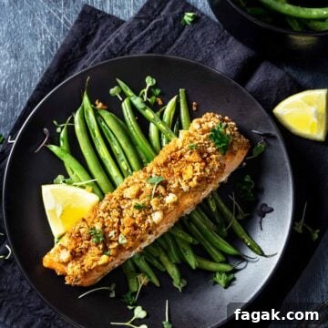 Baked salmon with mayonnaise topping and crouton-parmesan crust plated on green beans.