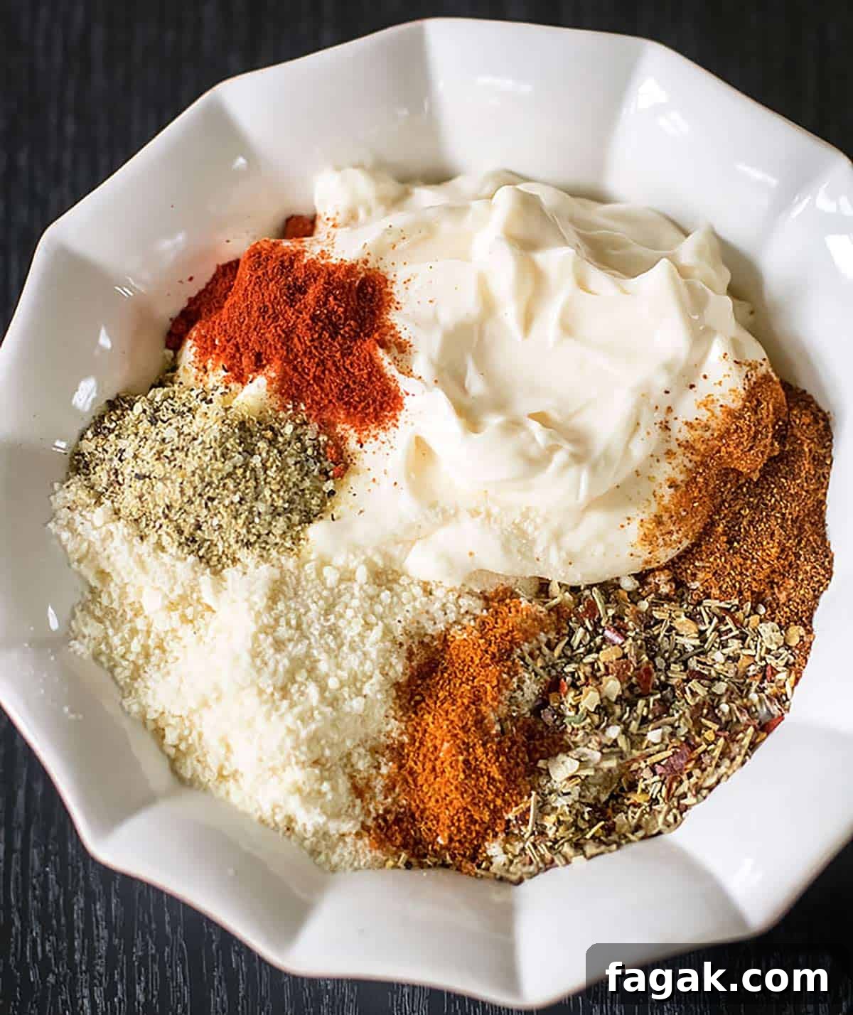 Mayo-parmesan topping ingredients in a bowl.