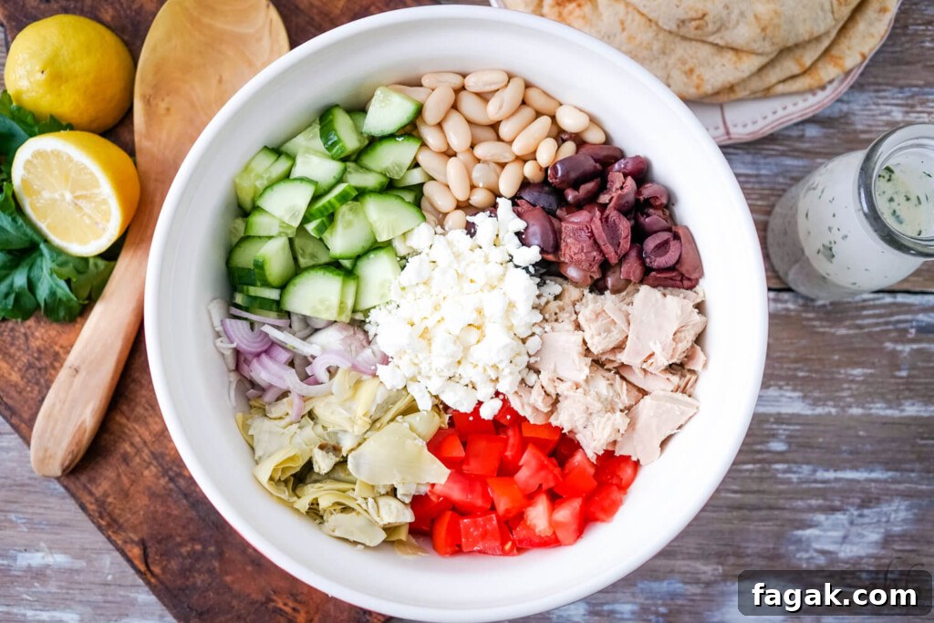 All of the ingredients for the tuna salad arranged in a serving bowl.
