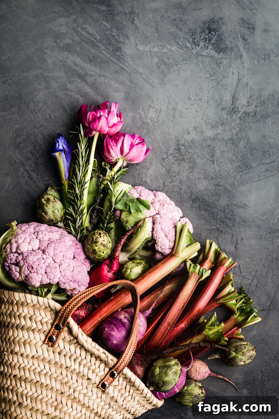 Early summer farmers market bounty haul of purple cauliflower, artichokes, radishes, beets, rhubarb and rosemary.