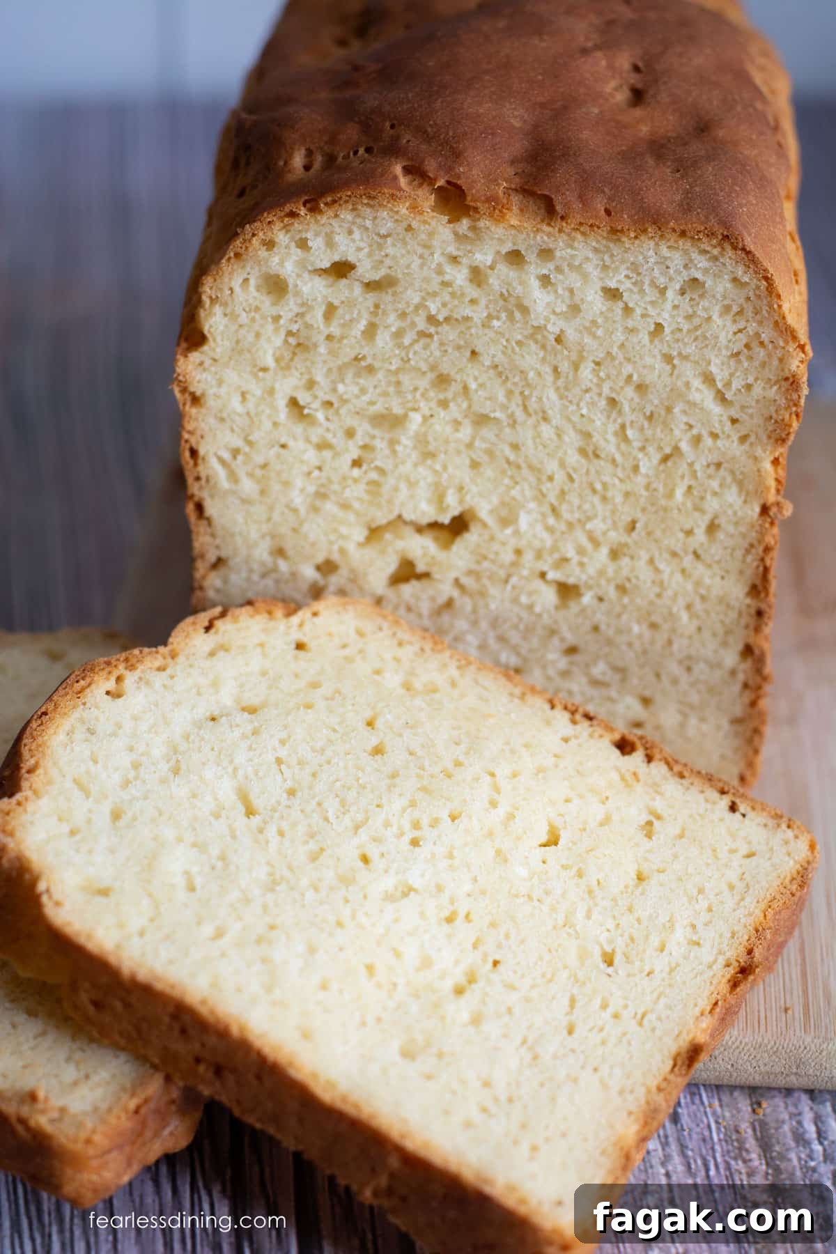 A photo of the gluten free Hawaiian bread tested with Cup4Cup flour blend. It is sliced on a cutting board.