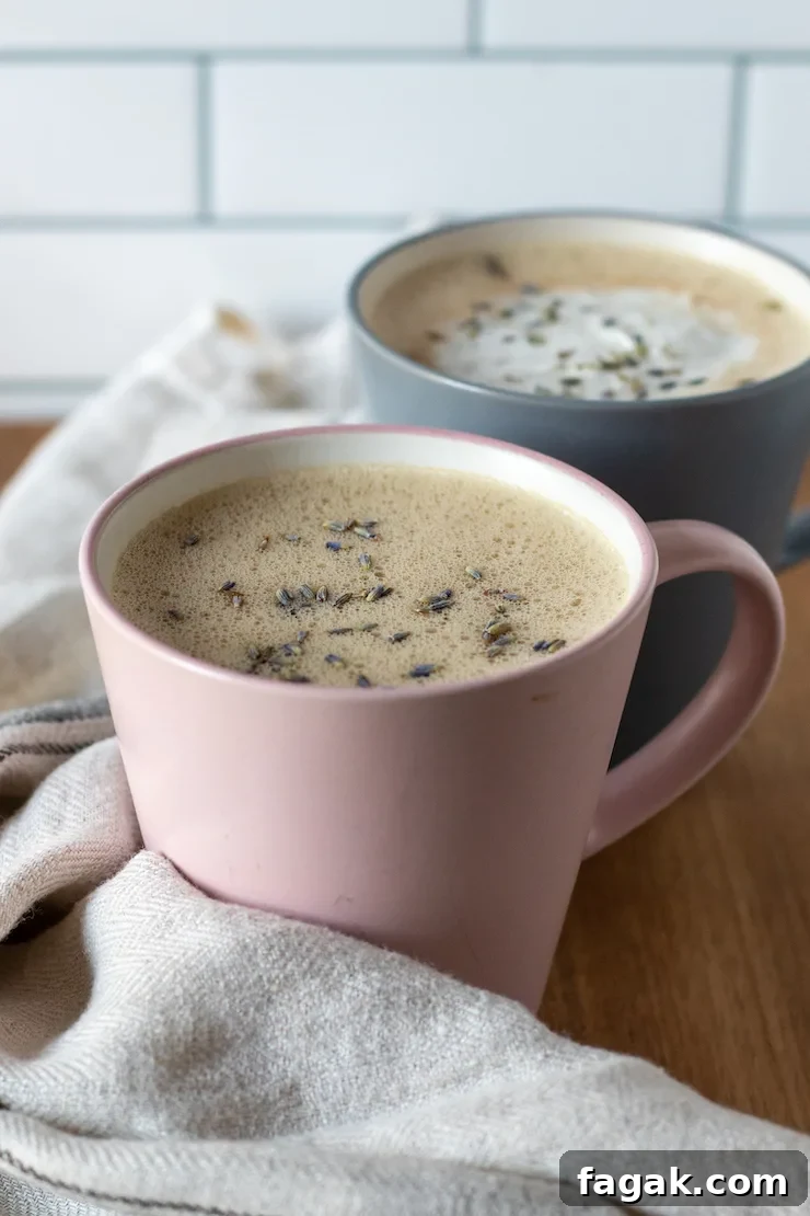 Two honey lavender lattes, one with whipped cream.
