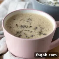 Honey lavender oat milk latte in pink cup.