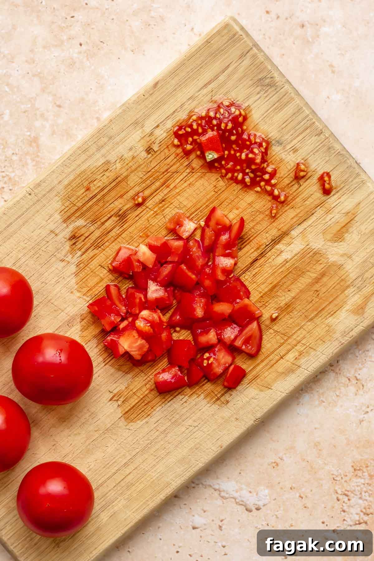Tomatoes chopped on a board.