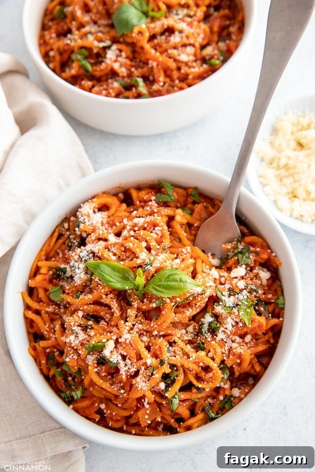 overhead shot of sweet potato noodles with Italian tomato sauce in a white bowl