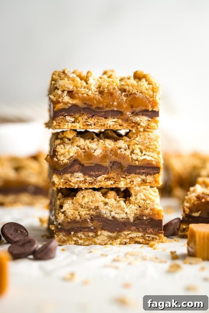 Three oat caramel bars stacked on top of each other.