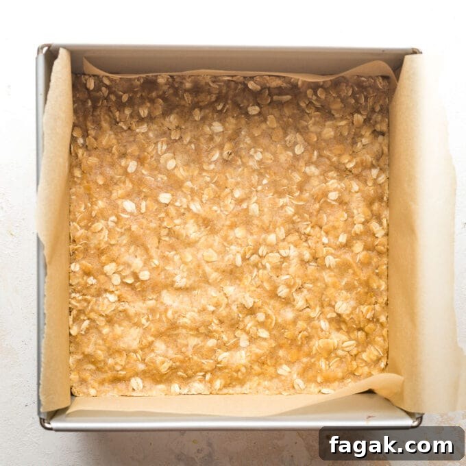 Oat cookie crust pressed into a 9x9" square pan.