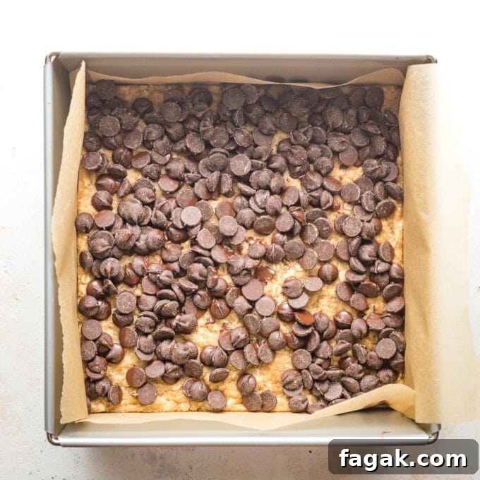 Chocolate chips spread on top of oatmeal cookie crust.