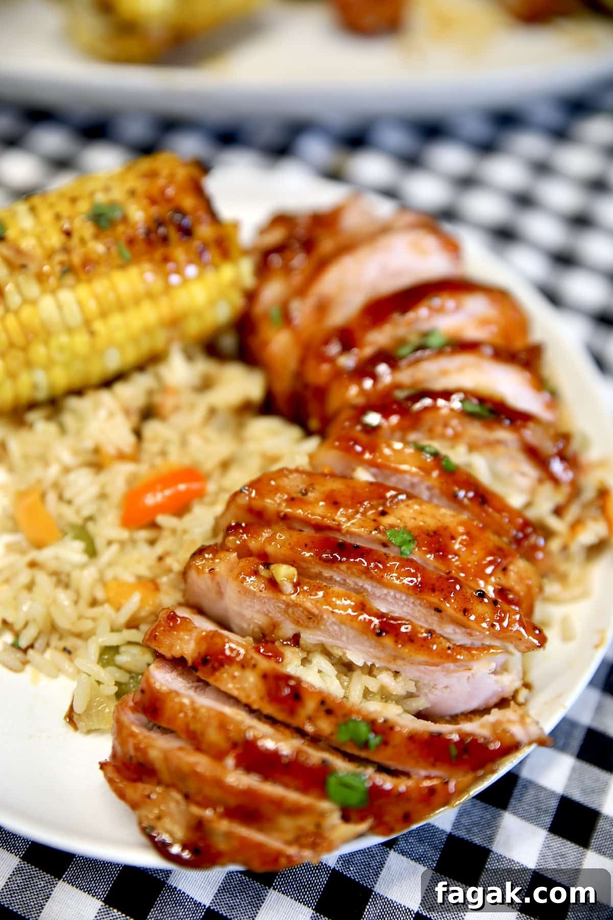 Sliced pork chops on a plate with bbq sauce.
