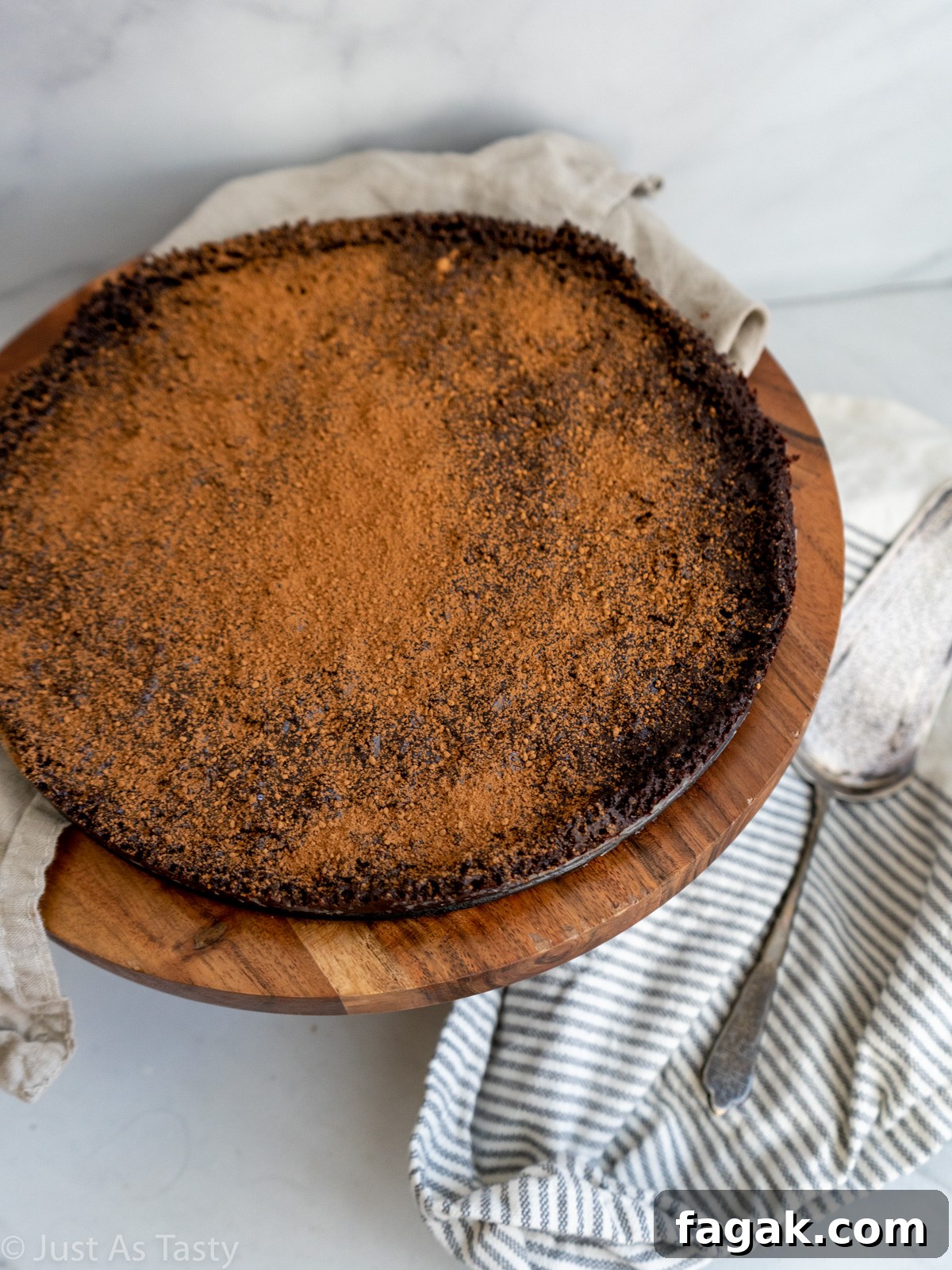 Flourless chocolate cake topped with cocoa powder.