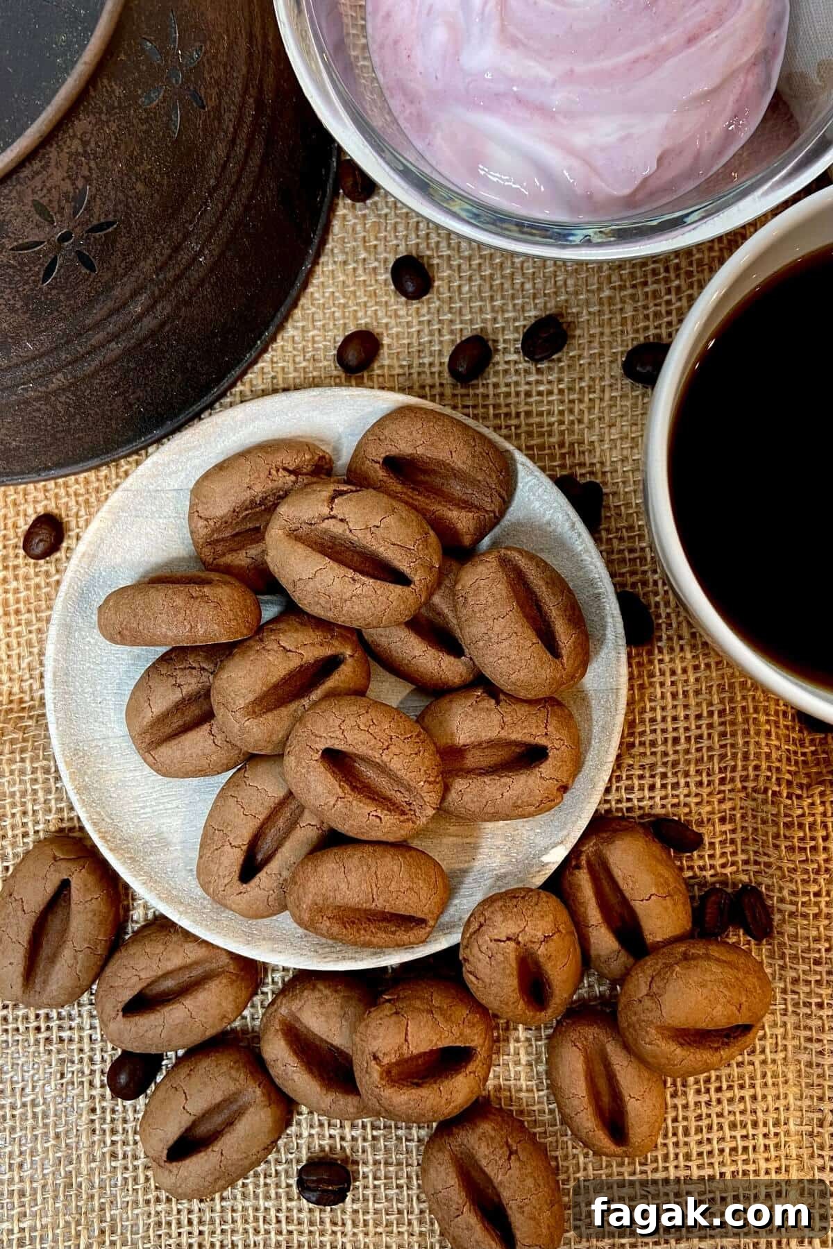 Cookies, with a dish of yogurt and a cup of coffee.