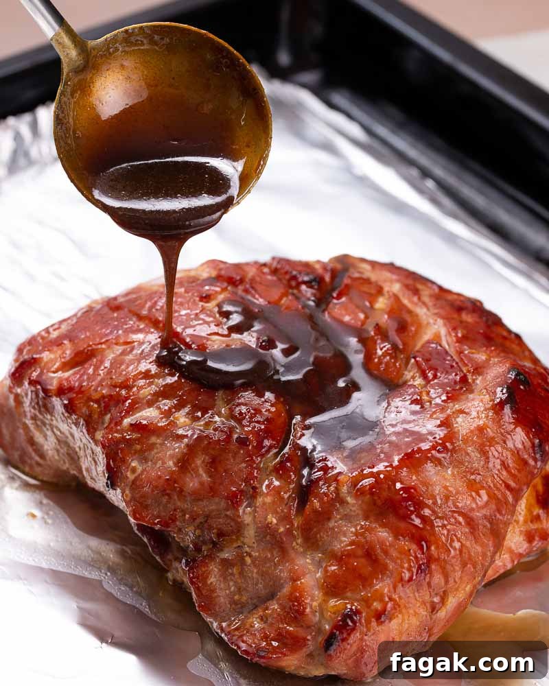 Glazed ham continuing to roast.