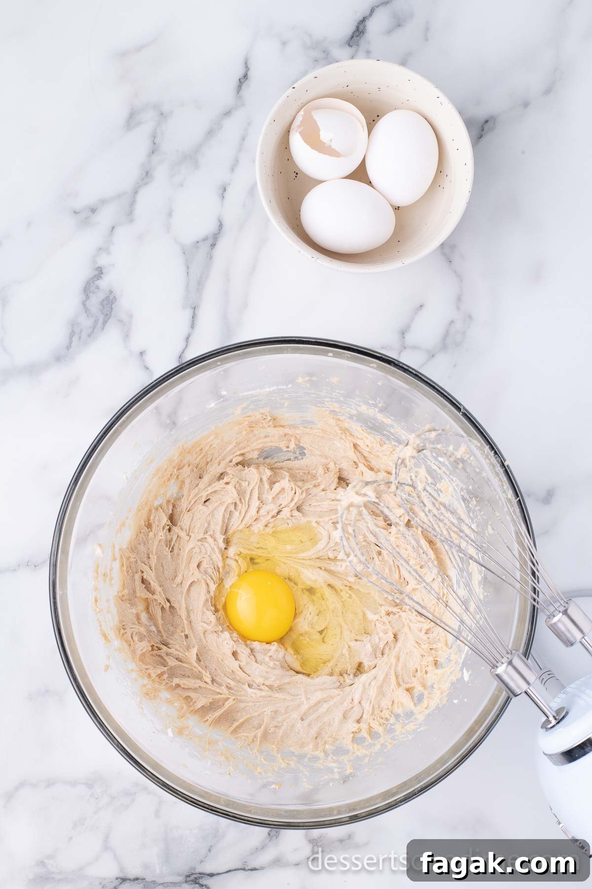 Eggs added to mixture in bowl.