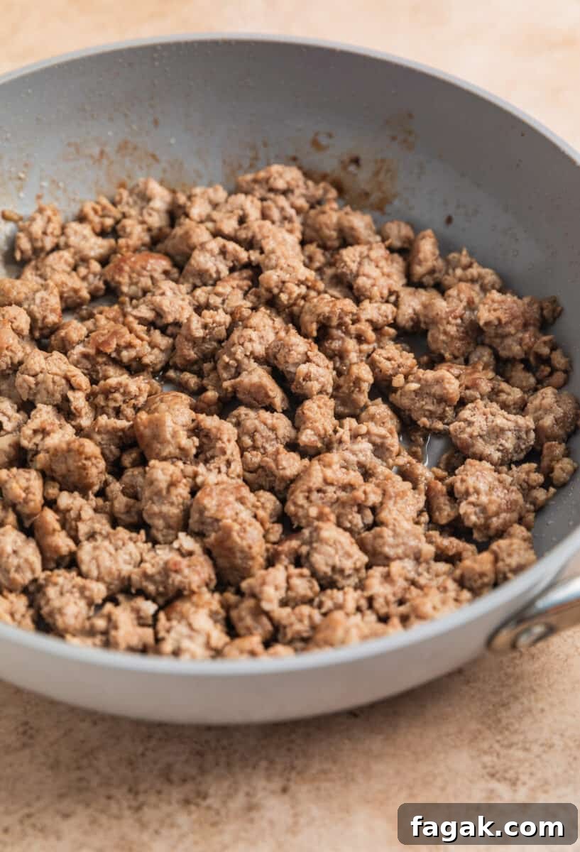 Browned ground pork in skillet.