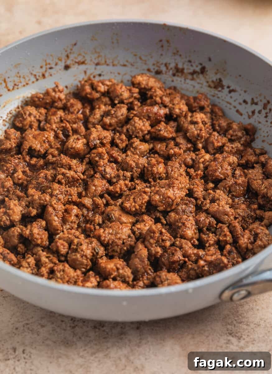 Ground pork taco meat cooked in skillet.