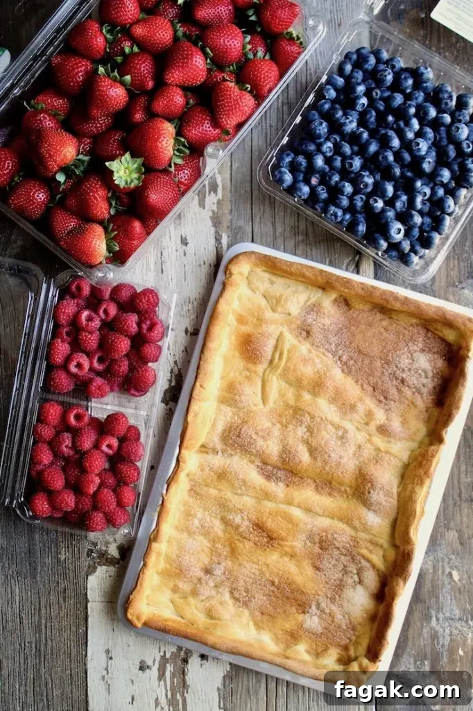 Red, White & Blue Fruit Pizza ingredients, fresh berries and crust in pan.