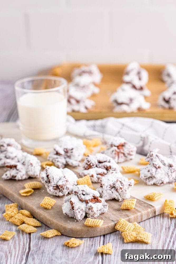 Crinkle cookies on a cutting board next to a glass of milk, easy muddy buddy cookies.