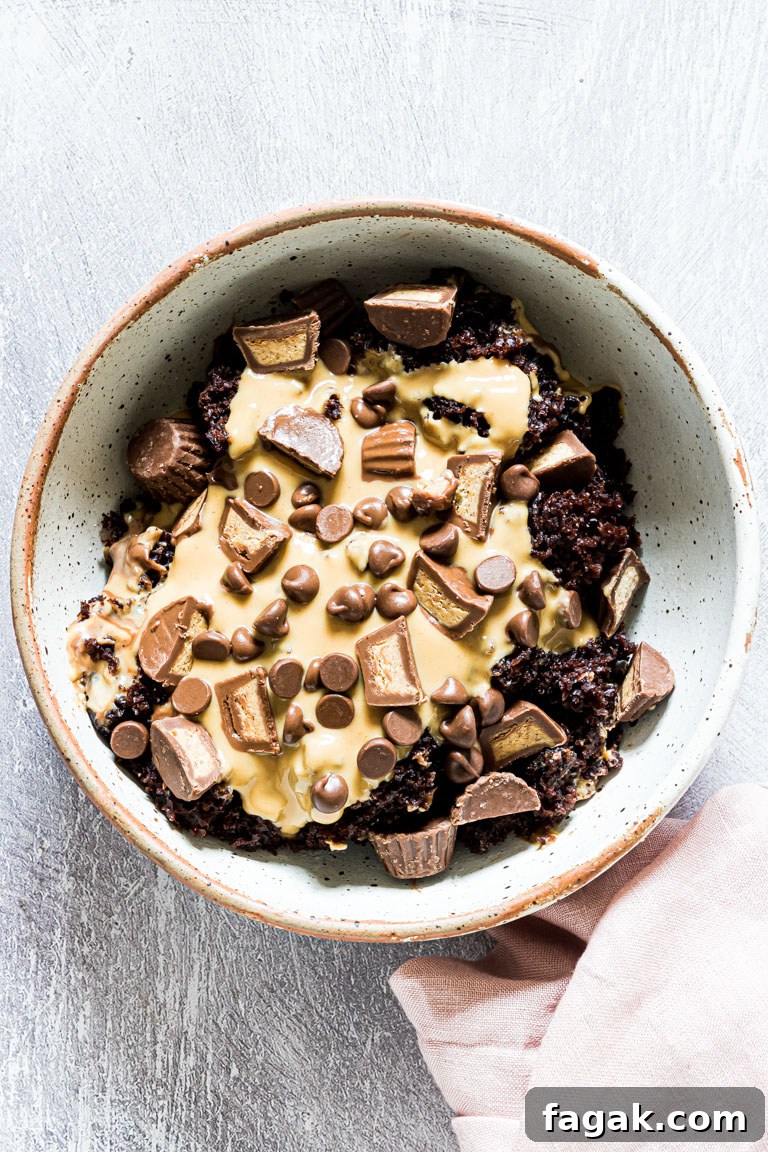 top down view of crockpot peanut butter chocolate cake served in s ceramic bowl