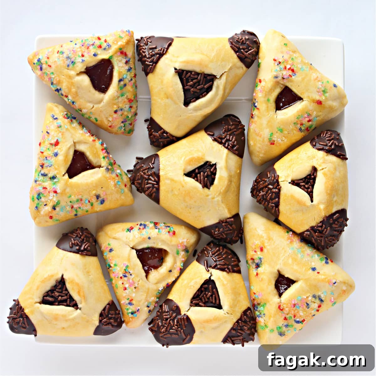 Classic Hamantaschen Recipe for Purim Cookies 6 Triangle pocket cookies decorated with chocolate or colored sugar on a square platter.