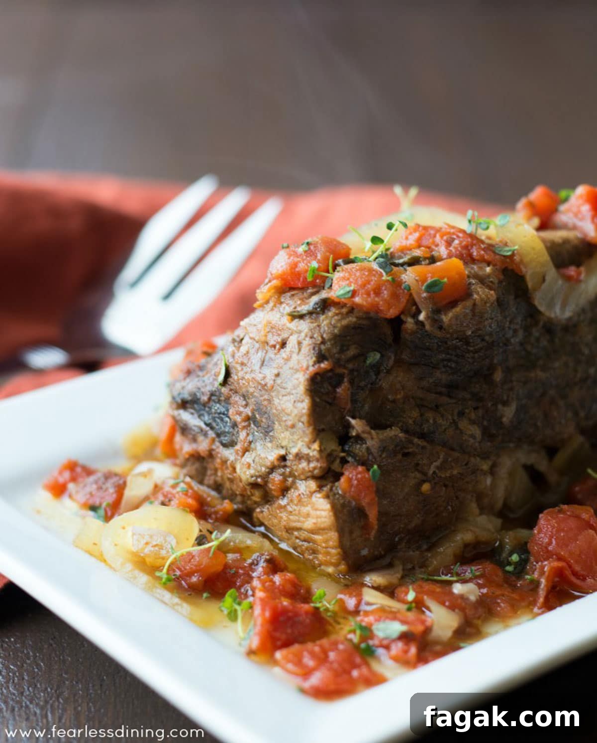 A large platter with a large chuck roast on it.